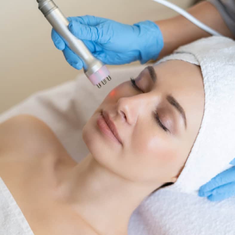 Woman receiving a non-invasive facial treatment at Dolce Aesthetics.